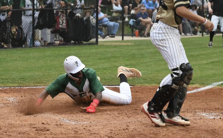 TFS' Chris Waldron slides in for a run during Saturday's state quarterfinal win. LANG STOREY/Staff