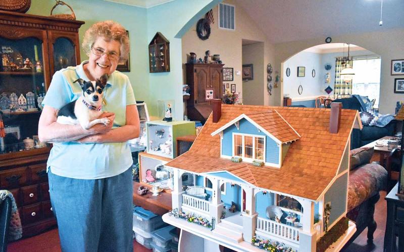 Joan Salute has been working with miniatures for about 35 years. She has 20-25 room boxes and a dollhouse displayed throughout her house, each one with a different theme. Salute holds her 8-year-old chihuahua named Heidi. (Photo/CHAMIAN CRUZ)