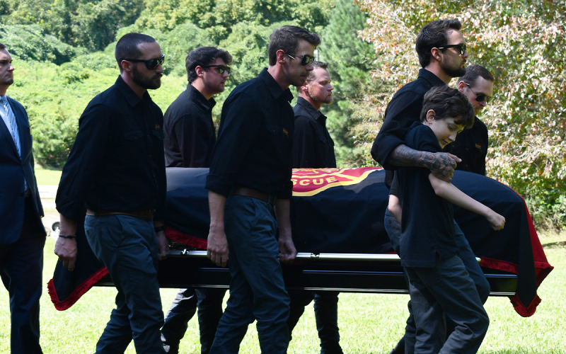 The Reiser family carries the casket of firefighter Garrett Reiser. BRIAN WELLMEIER/Staff