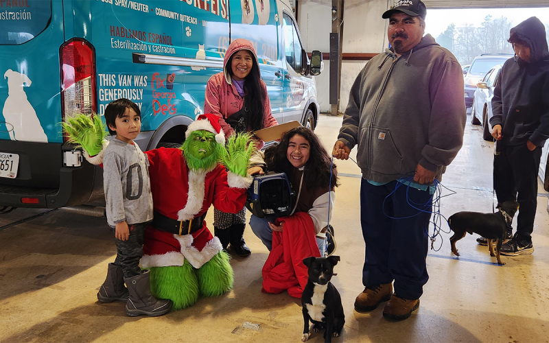 From left, son Alex, the Grinch played by Madi Nix, mother Rafela Ramos, daughter Yanet, husband Jose Rodriguez, son Esteban enjoy the free clinic hosted by Habersham County Animal Shelter and partners Dec. 10. SUBMITTED