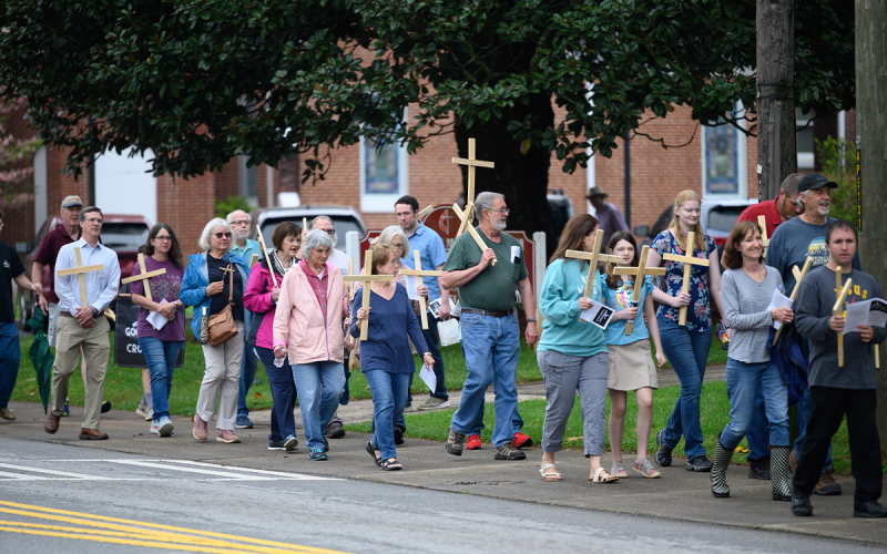 The Good Friday Cross Walk participants carry crosses through the streets of Clarkesville on Friday during the Good Friday Cross Walk hosted by Clarkesville First United Methodist Church. ZACH TAYLOR/Special