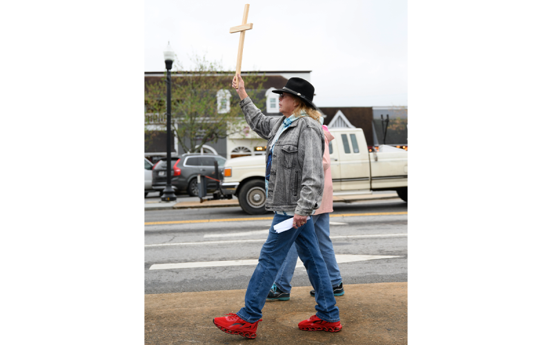 Linda Johnson holds her cross high while participating in the cross walk. ZACH TAYLOR/Special