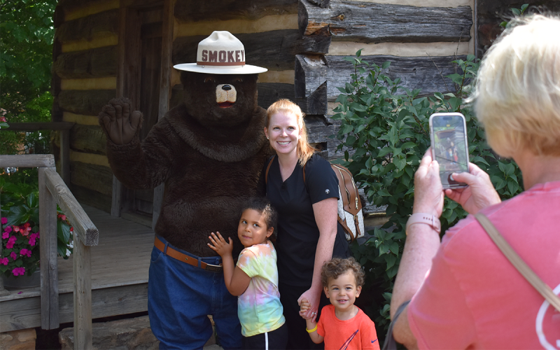 From left, Lorelai, Ashley and Major Davis pose with Smokey Bear while Linnely Dockery, also known as Yaya, takes a photo. EMMA MARTI/Staff