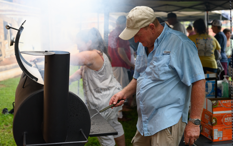 Scott Barnhart took on the challenge of cooking up the mouth-watering food in the rain.  ZACH TAYLOR/Special