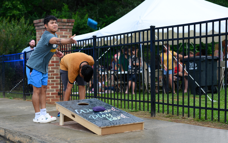 Marco Lorenzo played cornhole in the rain,  throwing his last bag into the board with his tongue sticking out. ZACH TAYLOR/Special