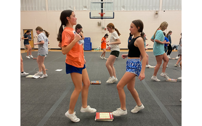 Ava Cash and Blair McEntire work out at cheer camp. KATHY AUSBURN/Submitted