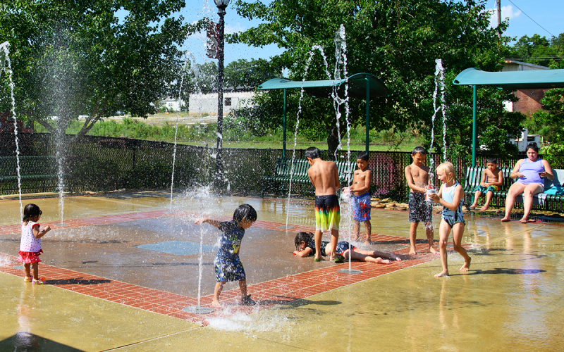 Parents watch as a group of kids play together in the Cornelia Splash Pad, which provides a great way to cool off on hot summer days. ZACH TAYLOR/Special