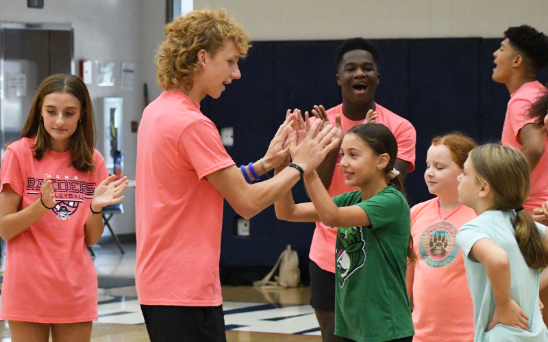 From left, Dalan James high-fives London Miller, Gracie Hubbard and Molly Copeland. LANG STOREY/Staff