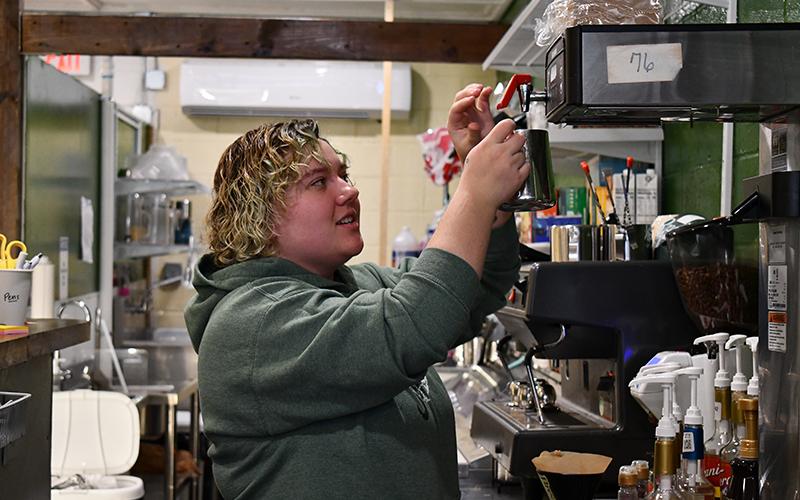 Cynthia Lincoln makes a latte at Man’s Best Friend Café in Clarkesville. JULIANNE AKERS/Staff