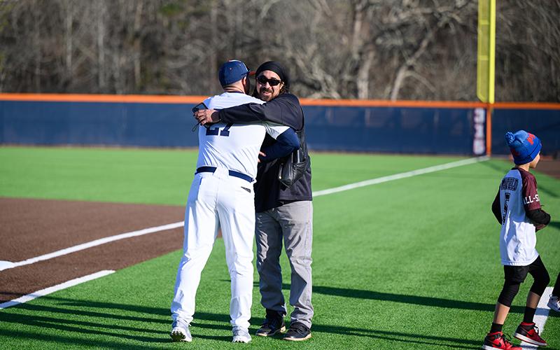 Coach Chris Akridge shares a moment with Seddrick Mayfield after Joaquim threw the first pitch. ZACH TAYLOR/Special