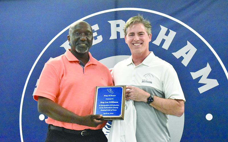 Roy Lee Williams (left) was presented by teammate Scott Lokey at the Ring of Honor dinner Wednesday. MATTHEW OSBORNE/Staff