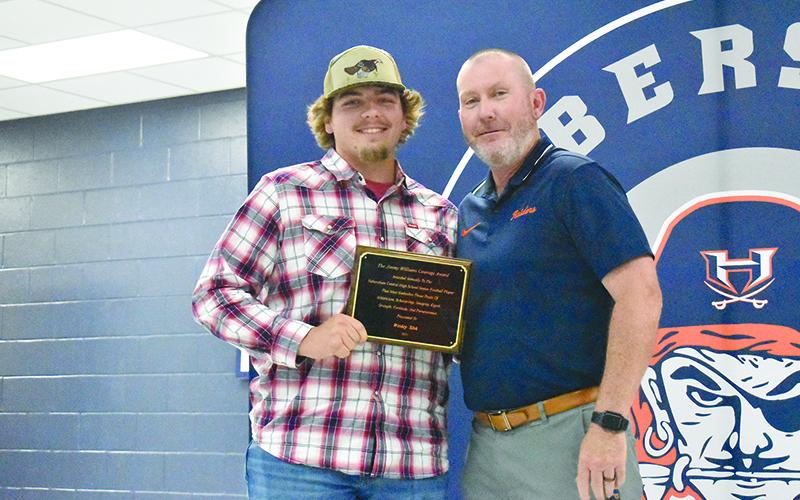 Habersham Central football coach Benji Harrison (left) presented senior Wesley Sisk with the Jimmy Williams Courage Award at Wednesday’s Ring of Honor banquet. MATTHEW OSBORNE/Staff