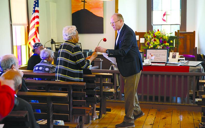 Stewart Swanson gives a rose to Evelyn Davis Harmon, who shared her fond memories of Deas Chapel and the people who created it at a  dedication ceremony Sunday for the restored organ at the historic church. ZACH TAYLOR/Special
