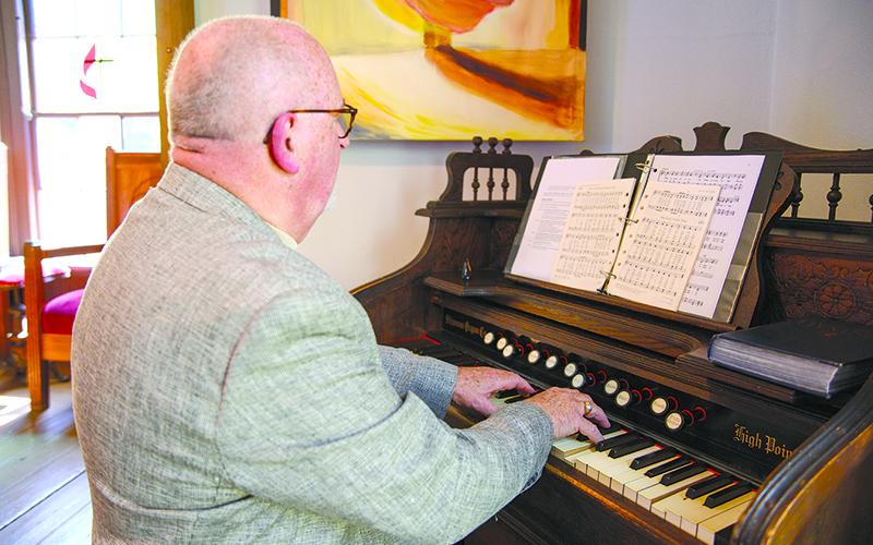 Bruce Brownlow, a local organist, plays the first notes of a hymn as the organ reeds fill the air in Deas Chapel with music for the first time in decades. ZACH TAYLOR/Special