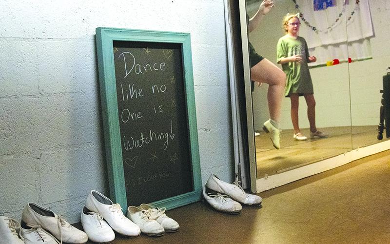 A sign that says "Dance like no one is watching," sits beside the mirror in the dance studio. ZACH TAYLOR/Special