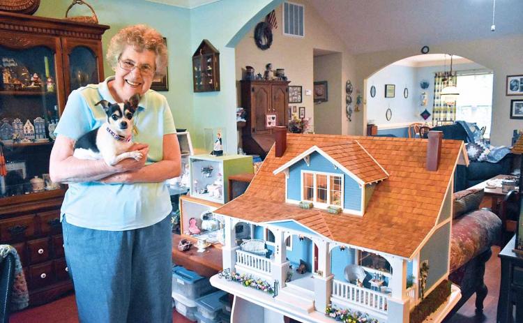 Joan Salute has been working with miniatures for about 35 years. She has 20-25 room boxes and a dollhouse displayed throughout her house, each one with a different theme. Salute holds her 8-year-old chihuahua named Heidi. (Photo/CHAMIAN CRUZ)