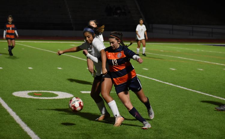 Habersham Central's Addie Penick fights for the ball with a Lanier High School defender Wednesday.