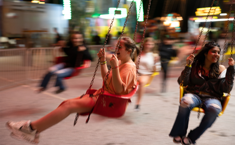 Jorja Baker (left) and Jimena Vera (right) laugh as they swing in circles at the fair. ZACH TAYLOR/Special