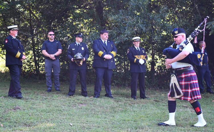 Firefighters Wesley Stubbs, Nick Davis, Tim Nunnally, Demorest Chief Jonathon Knight, and Cpt. Kevin Roy take a somber moment to remember their colleague Garrett Resier at a memorial service Wednesday. BRIAN WELLMEIER/Staff