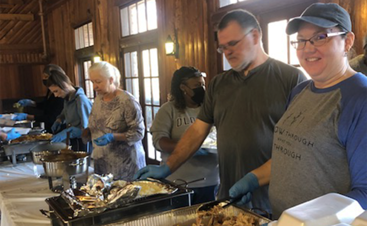 From the left, Lou Ann Duckett, Taymonia Jackson, Shane Adams and Shanna Adams serve a Thanksgiving meal at a previous Community Thanksgiving Dinner. SUBMITTED