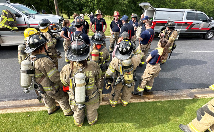 Habersham County Emergency Services and Lee Arrendale State Prison firefighters debrief after extinguishing Monday morning’s fire at The Orchard Golf Club Clubhouse.  HABERSHAM COUNTY/Submitted