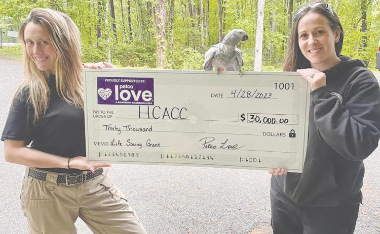 Habersham County Animal Care and Control Director Madi Nix and Administrative Assistant Olivia Whitfield, and “Bird” are shown with the symbolic grant check.