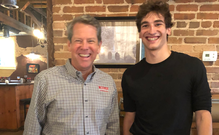 Joshua  Huizing (right) snaps  a pic with Gov. Brian Kemp at The Attic restaurant in Clarkesville. SUBMITTED