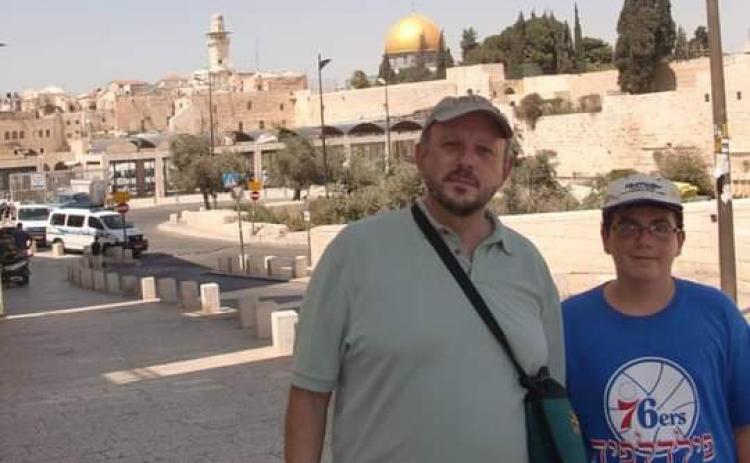 Joshua Peck, left, and his son Ari tour in Jerusalem in 2011. The Temple Mount, regarded as a holy site in Christianity, Islam and Judaism, stands behind them. SUBMITTED