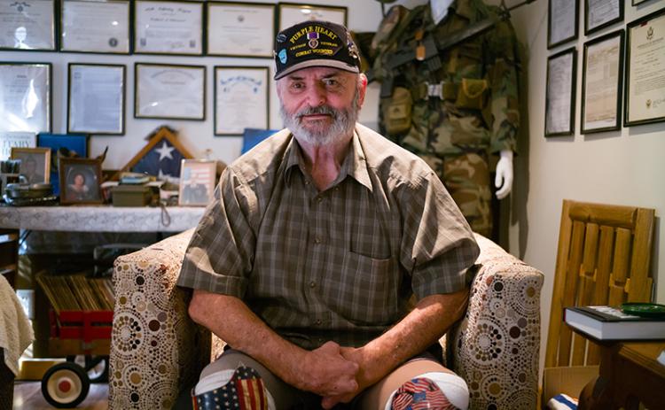 zVietnam veteran and Purple Heart recipient Ray H. Bowen sits in the military memorabilia room in the house of friend and fellow Vietnam veteran Charlie Mack Booth. ZACH TAYLOR/Special