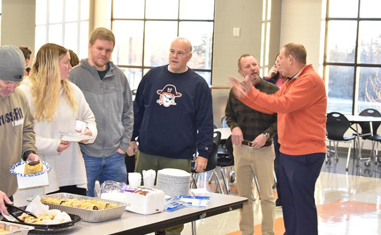 Habersham Central Principal Dr. Jonathan Stribling converses with Assistant Principal Donnie Bennett as teachers (from left) Jeff Wilson, Margaret Greenwald, Shane Hotalen and Matt Hudlow grab some breakfast at an appreciation meal put on by parents Tuesday morning at the school. MATTHEW OSBORNE/Staff