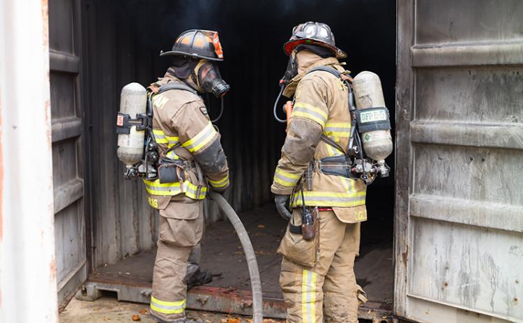 Cameron Lucas and Payton Cagle discuss maneuvers around the burning training building in November. ZACH TAYLOR/Special