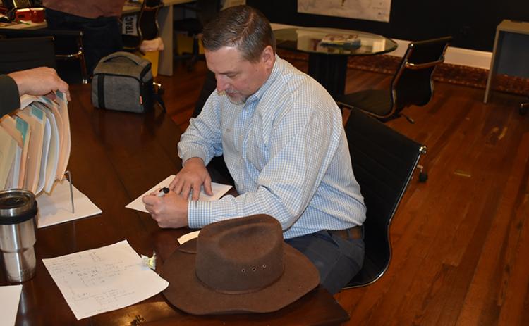 Habersham County Chairman Ty Akins signs paperwork Wednesday to run for the District 5 seat again. MATTHEW OSBORNE/Staff