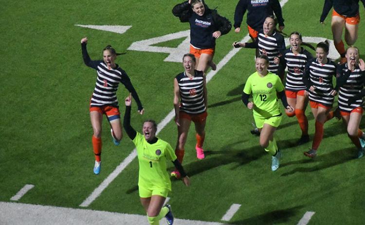 Habersham Central’s girls soccer team runs to the stands to acknowledge the crowd that sat through 100 minutes of rain and wind to watch them earn a program-altering 2-1 win over Jackson County on Friday. Scan above for Tuesday’s match results. MATTHEW OSBORNE/Staff 