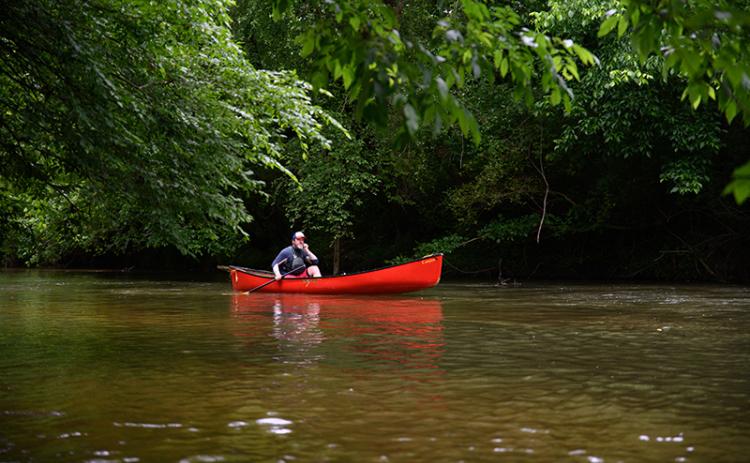 A fisherman sits in his canoe in the Soque River. ZACH TAYLOR/Special