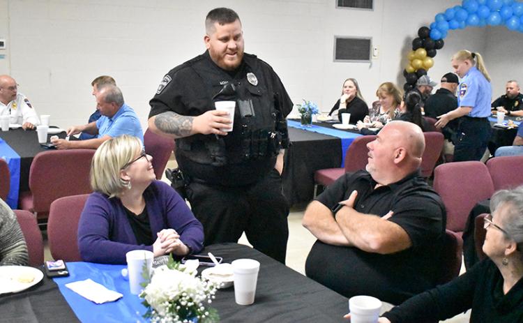 Outgoing Demorest  Police Chief Robin Krockum (seated right) and his wife Meadow talk with Officer Ty Moss at lunch Friday. MATTHEW OSBORNE/Staff