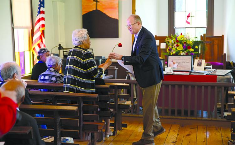Stewart Swanson gives a rose to Evelyn Davis Harmon, who shared her fond memories of Deas Chapel and the people who created it at a  dedication ceremony Sunday for the restored organ at the historic church. ZACH TAYLOR/Special
