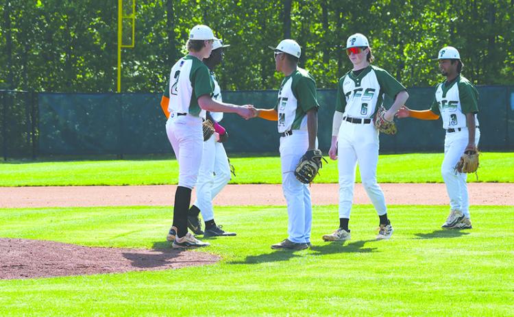 Tallulah Falls’ Gregory Mendez, Andrew Skvarka and Diego Gonzalez hype up pitcher Chase Pollock before the start of an inning against Oglethorpe in the first round of the playoffs. LANG STOREY/Staff