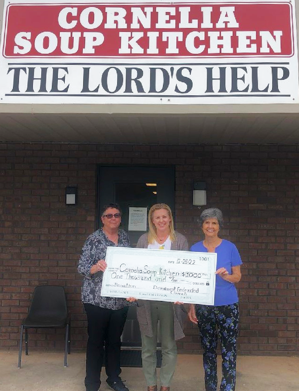 Pastor Joyce Acree and President of Cornelia Soup Kitchen Christy Bowen accept a check from Alta Moseley, Demorest Methodist Congregational Federated Church Treasurer. SUBMITTED