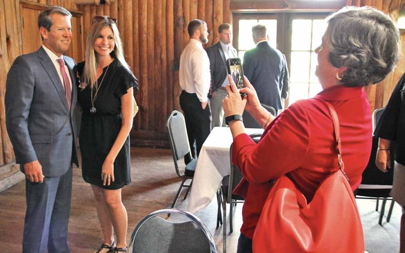 Gov. Brian Kemp and Habersham Chamber of Commerce President Mary Beth Horton get their picture taken by Chamber Administrative Assistant Kristy Hammond. (Photo/ERIC PEREIRA)