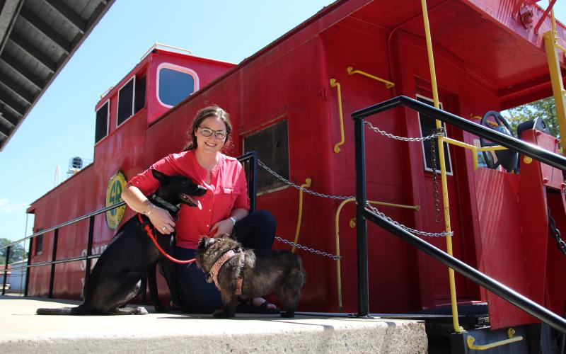 Eric Pereira/ Cornelia Tourism Coordinator Brittain Williams and her dogs Cerin and Tara are shown at the Cornelia Depot. Visitors are allowed to bring their dogs into the Cornelia Historic Train Depot and Museum.