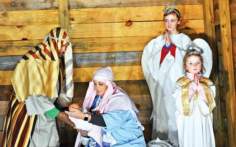 Left to right, are Tore Christiansen as Joseph and Monica Christiansen as Mary holding baby Jesus, while angels McLain Allen and Quinn Allen look on.