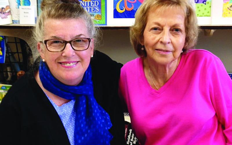 Director of the Children’s Art Gallery Jan Walker, left, poses with the late Glenda Boling. Boling supported several local authors and artists while operating Books with A’peal.