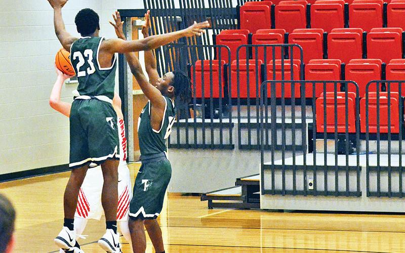 Rabun County’s Connor McKay is swarmed by Tallulah Falls defenders Devonte Allen (23) and Simeon Respress during Friday night’s game. The Indians turned the game around with a full-court press before falling late.