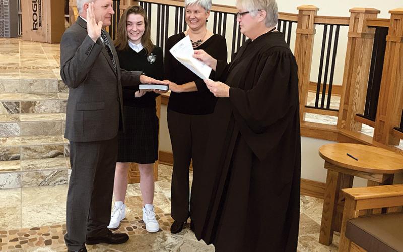 Newly elected District 5 Habersham County Commissioner Tim Stamey is sworn in Monday at Tallulah Falls School along with daughter Sam Stamey, wife Kerry Stamey and Habersham County Probate Judge Pam Wooley.