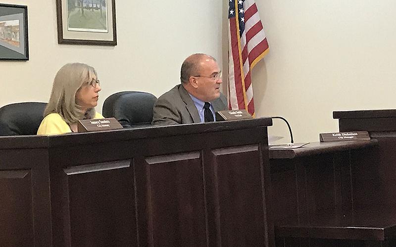 New Clarkesville city manager Keith Dickerson reports to the council Monday night as city clerk Glenda Smith looks on.