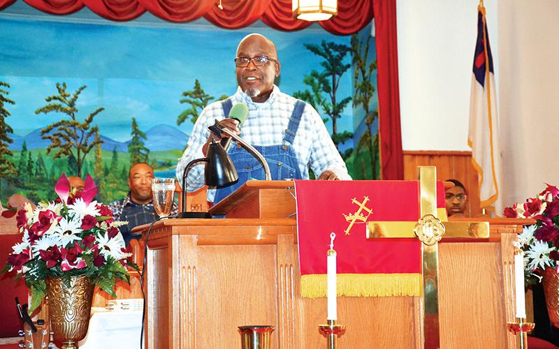 Bishop Ernest Burns speaks to the assembled guests at Shady Grove Baptist Church after Sunday’s Dr. Martin Luther King Jr. Peace Walk in Cornelia. He braved the cold with the rest of the walkers in downtown Cornelia as he helped organize the march, leading everyone in song as well.