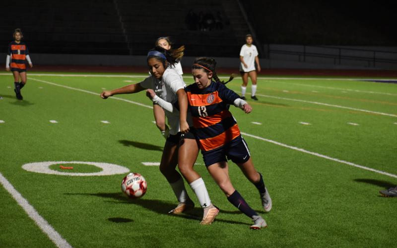 Habersham Central's Addie Penick fights for the ball with a Lanier High School defender Wednesday.