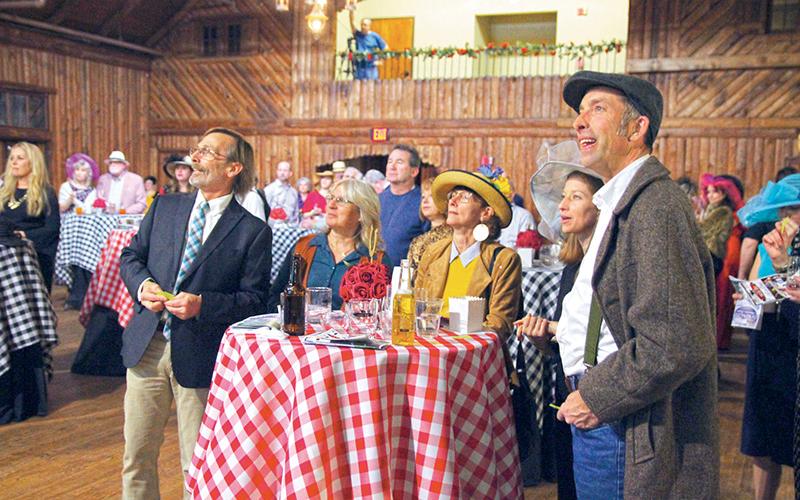 Attendees of “Night at the Derby” at the Cornelia Community House got to bet on virtual horses for chances to win raffle tickets and prizes.