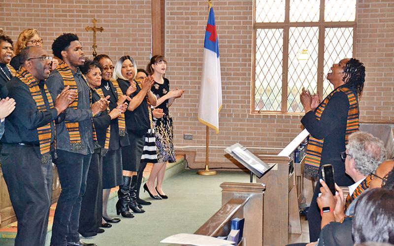 Portia Burns conducts the Alliance Community Gospel Choir during the opening act of the concert Sunday.