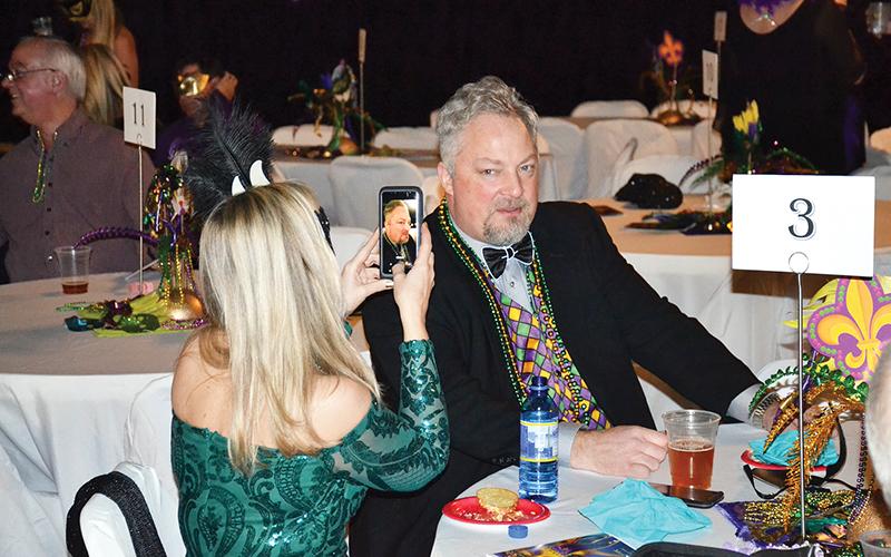 Joanna Hidreth tries to get the perfect picture of David Sosby’s glowing bow tie.